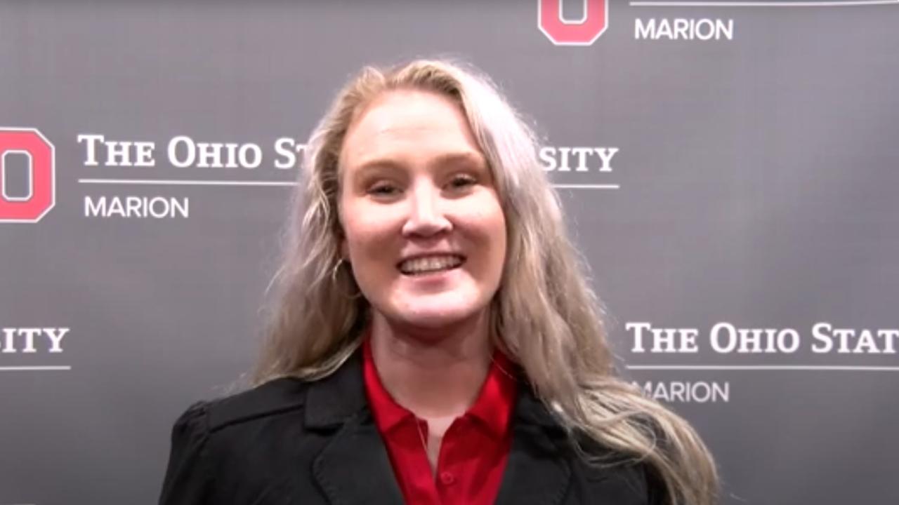 Caroline Anderson poses in front of an Ohio State Marion photo backdrop