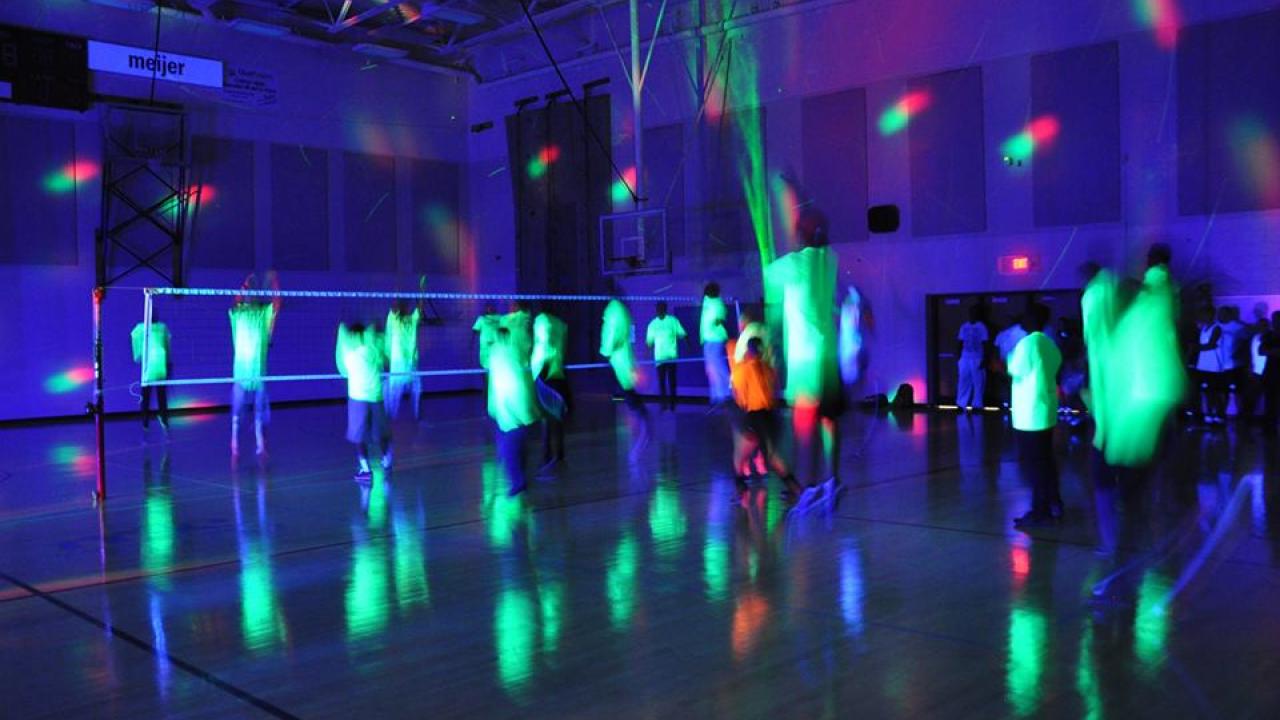 students playing glow in the dark volleyball