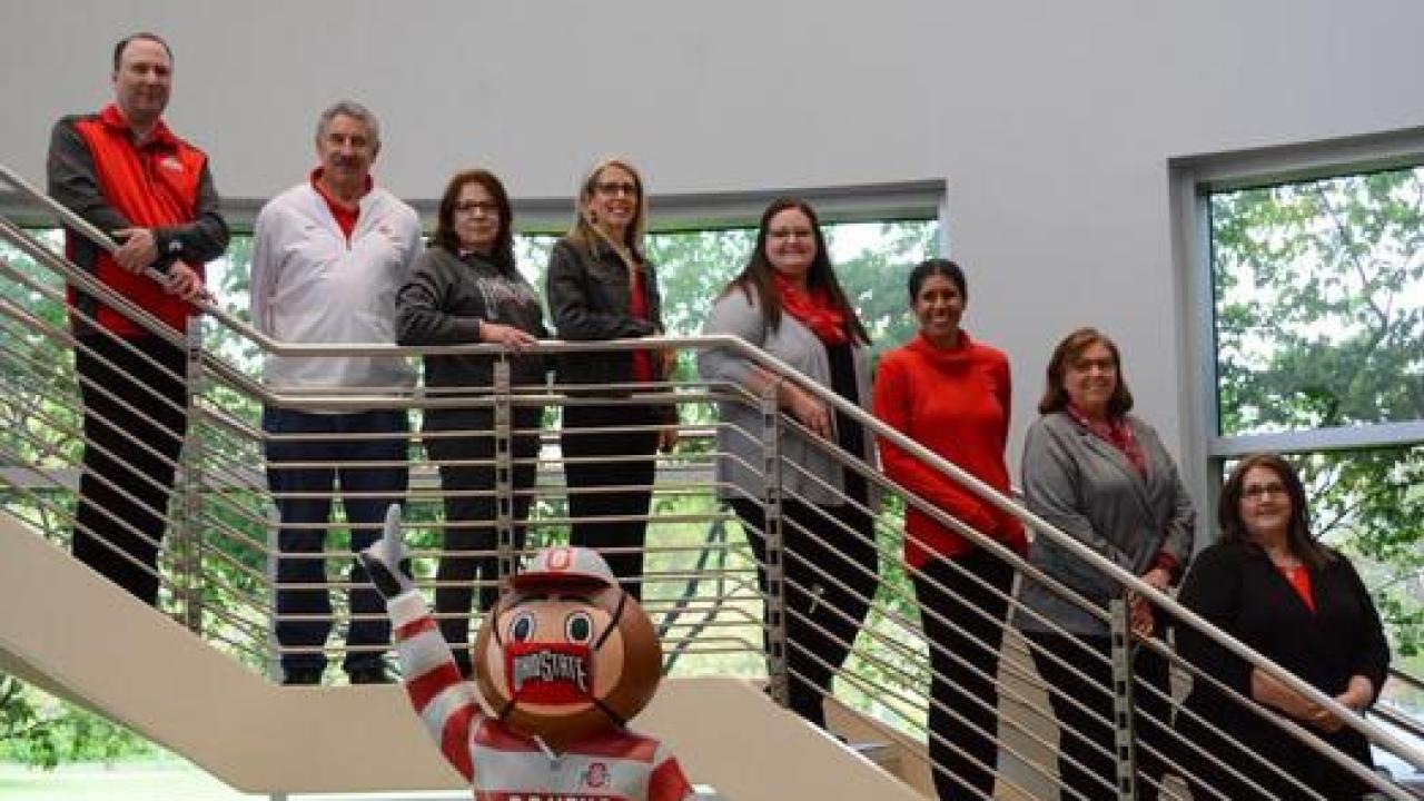academic advising staff pose for a photo on the stairs of maynard hall
