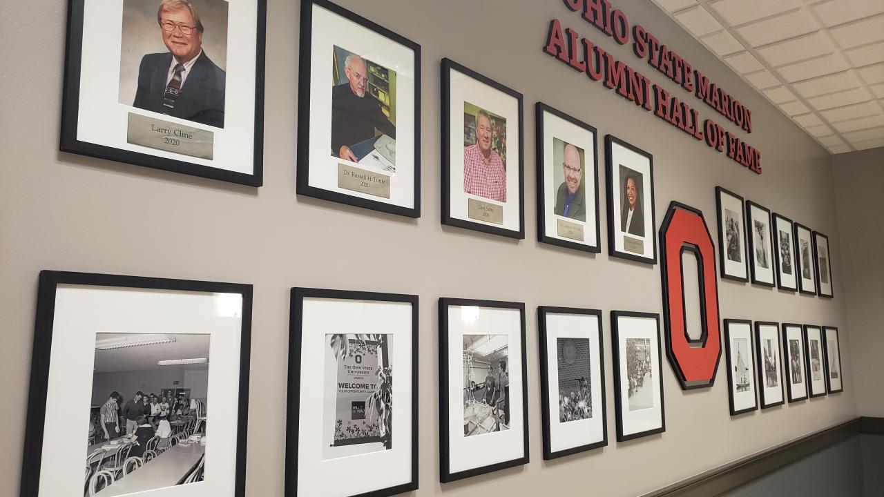the alumni hall of fame wall with portraits of all the inductees 