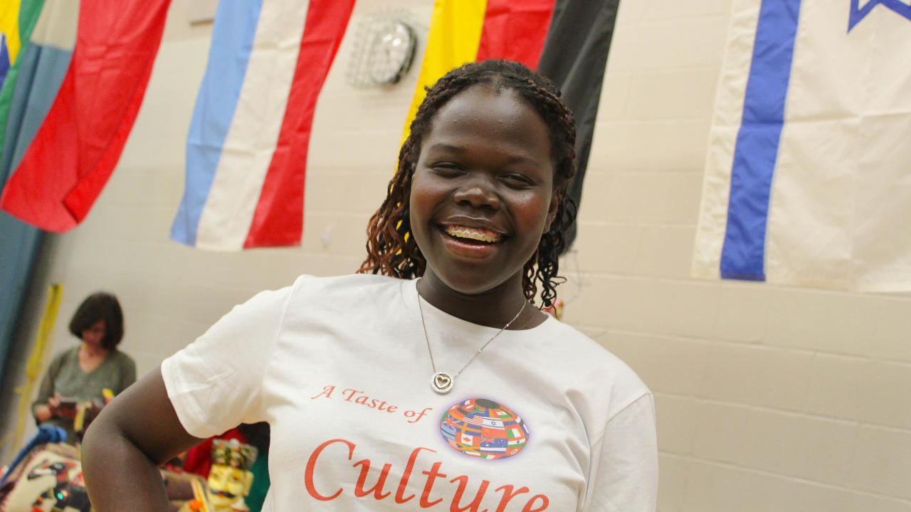 a student smiling at A Taste of Culture