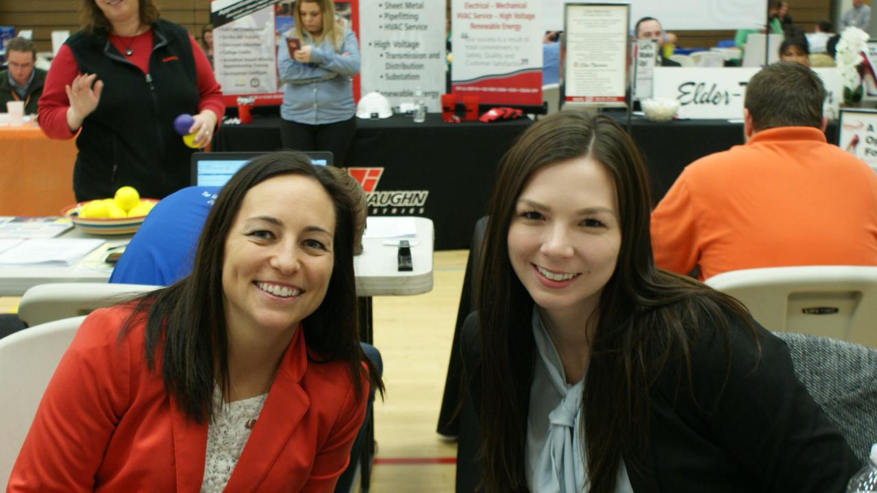 two women posing for photo at the job and internship fair