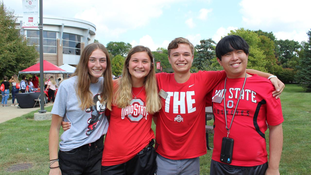four students of The Ohio State University at Marion posing for photo in front of a Welcome Week event