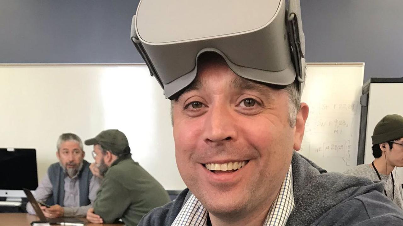 Jeffrey Kuhn smiling for picture with virtual reality headset on