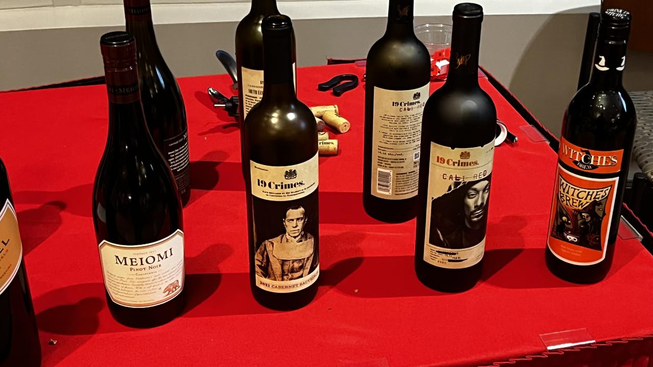 8 bottles of wine on a red table cloth