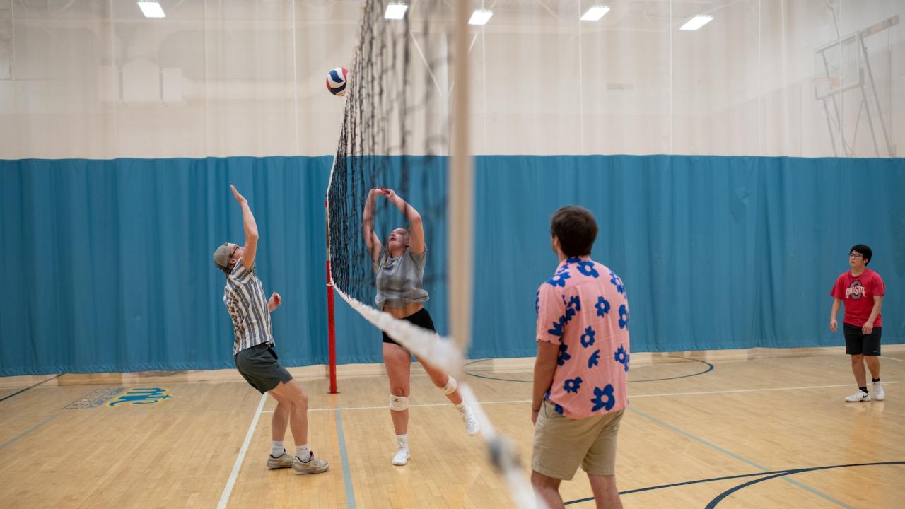 group of students playing volleyball