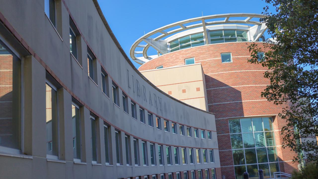 outside of campus library on a fall day with blue sky