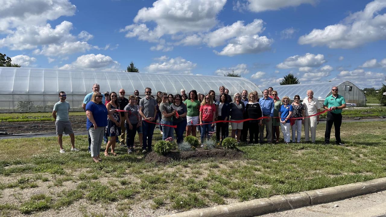 group of people ribbon cutting the microfarm