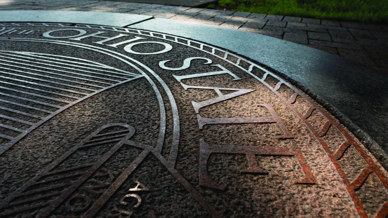 Ohio State seal outdoors at dusk