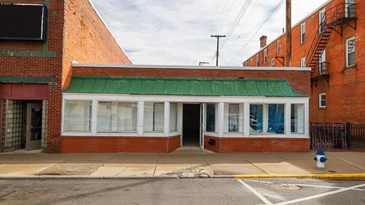 one story building with a green awning set in midwest downtown